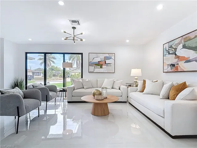 Living room with recessed lighting and a chandelier