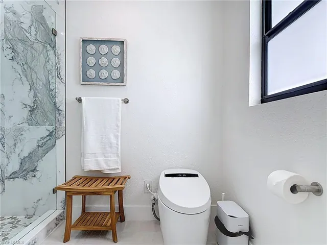 Full bathroom with a walk in shower and toilet