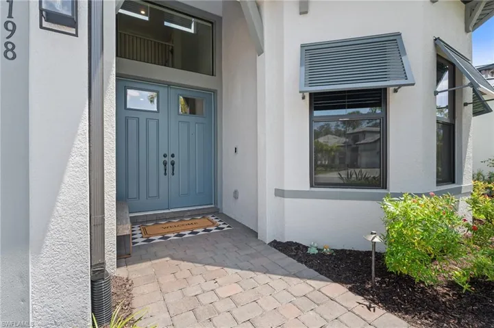 View of exterior entry with stucco siding