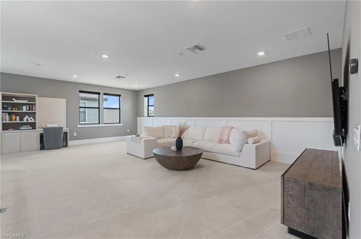 Living area featuring, recessed lighting, and light carpet