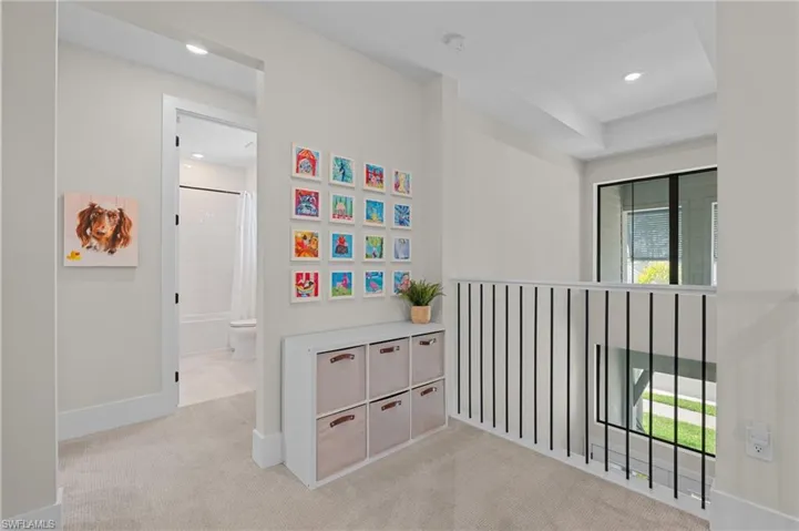 Hallway featuring recessed lighting, carpet flooring, baseboards, and a healthy amount of sunlight