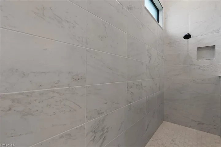 Full bathroom featuring tiled shower