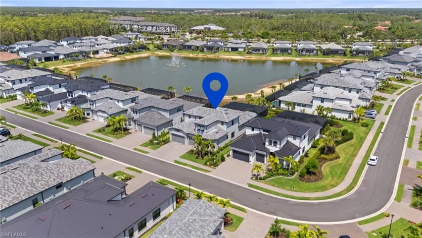 Birds eye view of property featuring a water view and a residential view