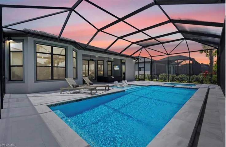 View of swimming pool featuring a ceiling fan, a sunroom, a lanai, a patio, and a pool with connected hot tub