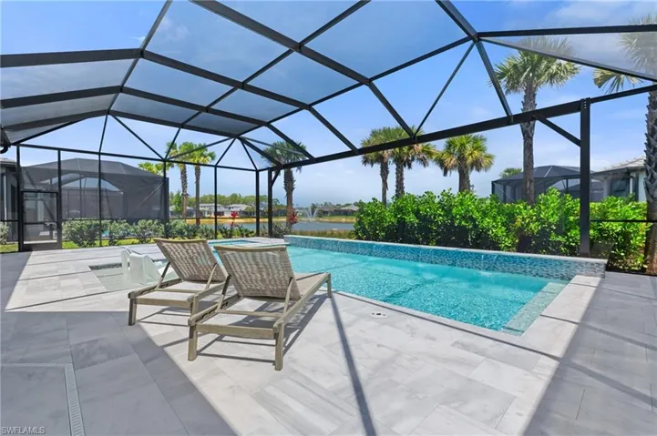 Outdoor pool featuring a patio and a water view