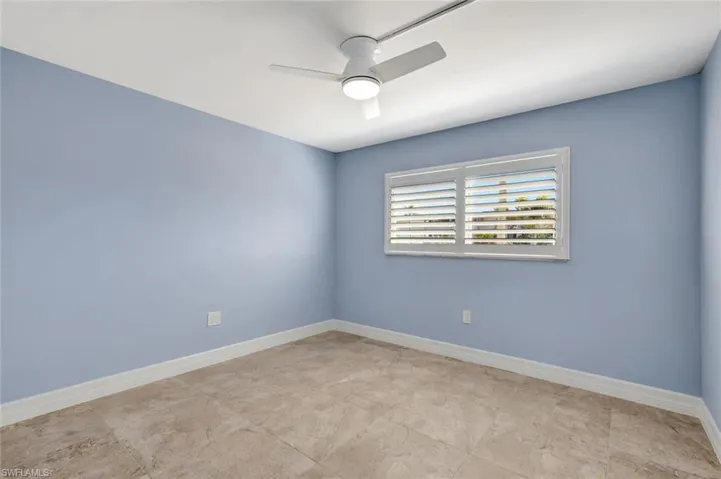 Empty room with baseboards and ceiling fan