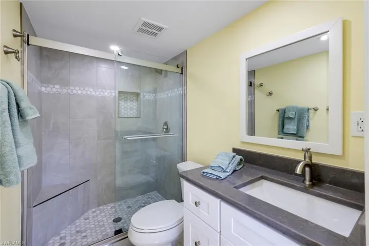 Primary bath featuring vanity and a stall shower