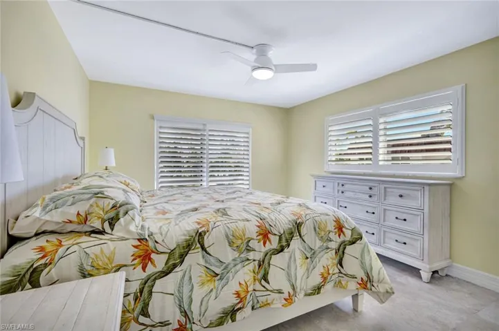 Bedroom with a ceiling fan and baseboards