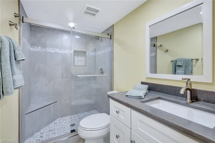 Bathroom with vanity and a shower stall