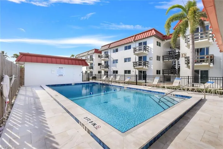 Community pool with a patio