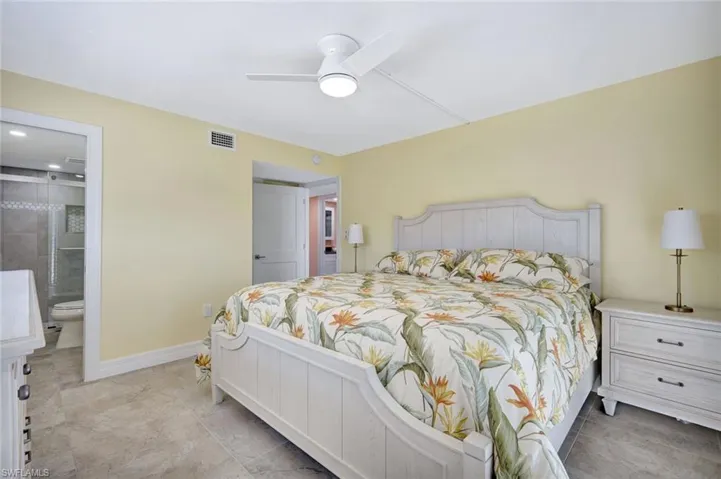 Bedroom with a ceiling fan and ensuite bathroom