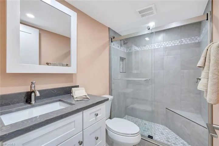 Full bath featuring vanity and a stall shower
