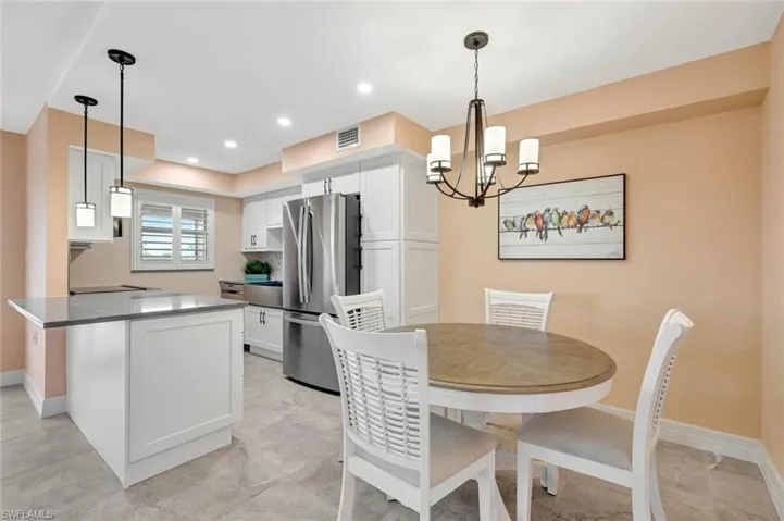 Dining room featuring baseboards and hanging lights