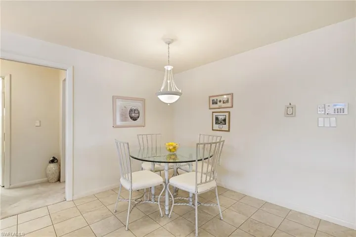 Dining area featuring light tile patterned flooring and baseboards