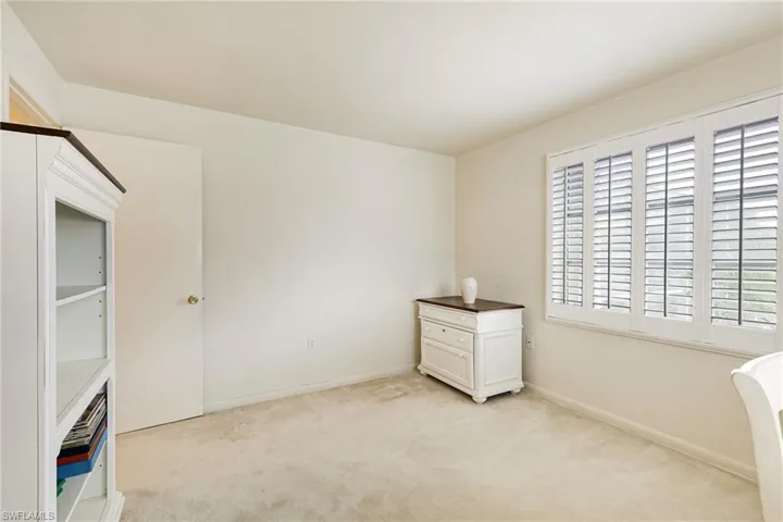 Unfurnished bedroom featuring light colored carpet and baseboards