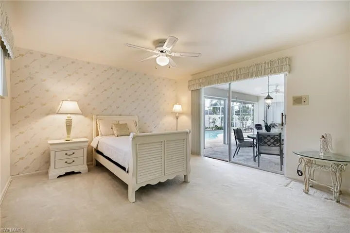 Bedroom featuring wallpapered walls, access to outside, light carpet, baseboards, and ceiling fan