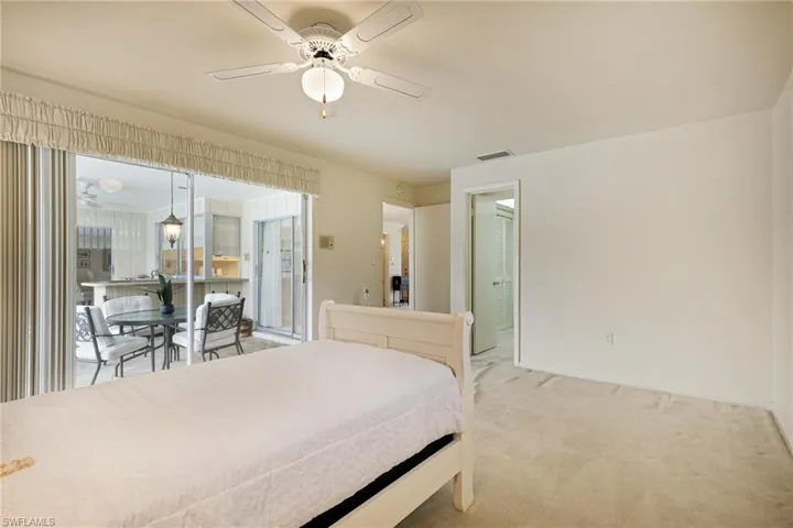 Bedroom with light colored carpet and baseboards
