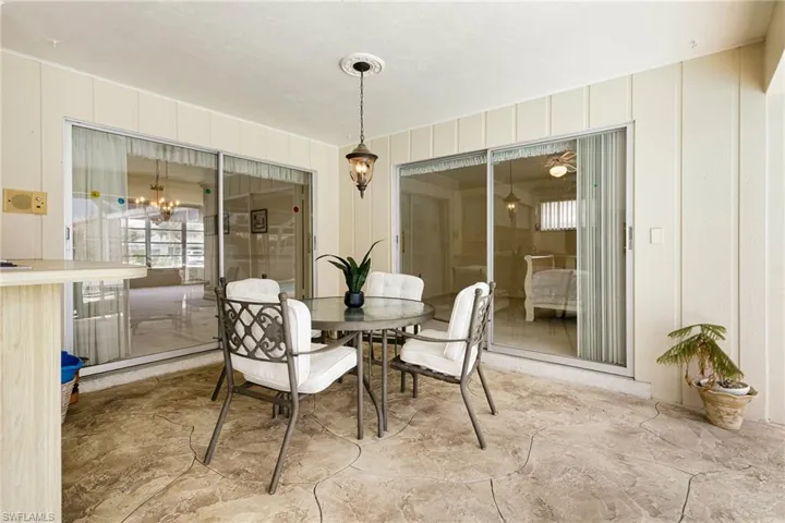 Dining space featuring a decorative wall and a chandelier