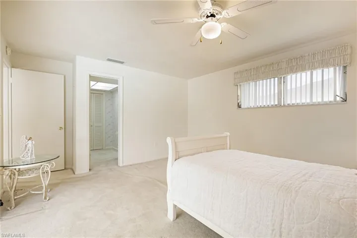 Bedroom featuring light colored carpet and a ceiling fan