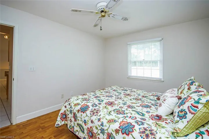 Bedroom featuring wood finished floors and a ceiling fan