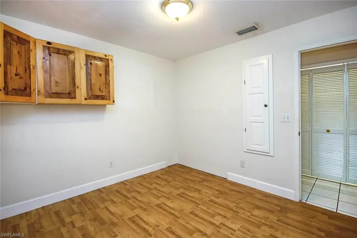 Spare room featuring wood finished floors and baseboards