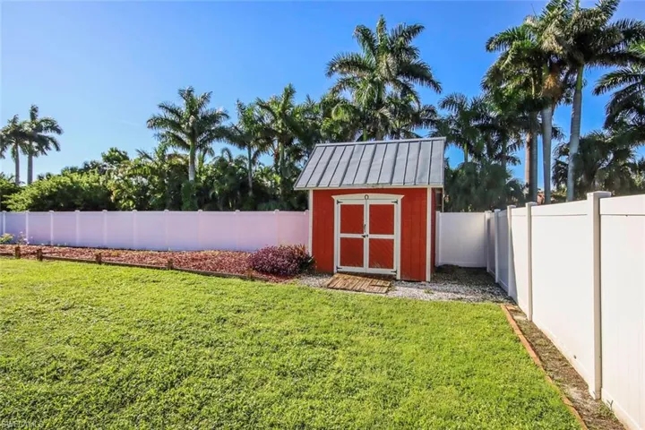 View of shed with a fenced backyard