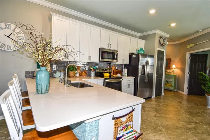 Quartz counters, deep sink, stylish backsplash, pantry & plenty of cabinets!