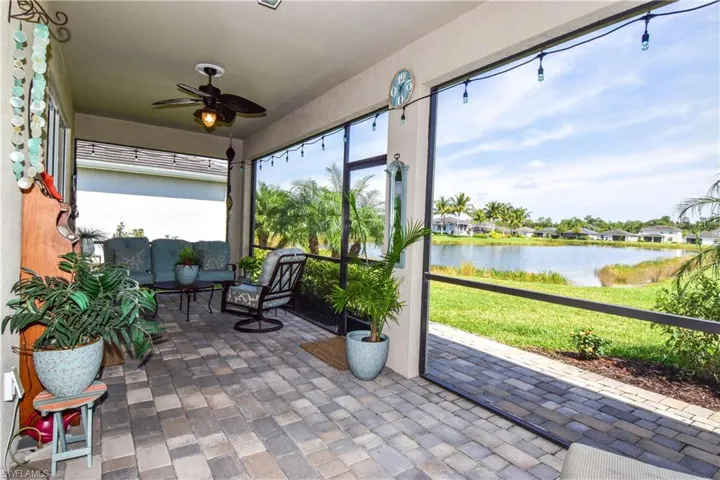 The amenity center nestled across the tranquil lake, offers a serene backdrop that enhances your living experience and provides a peaceful retreat from your spacious lanai.