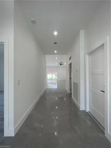 Hall featuring tile patterned floors
