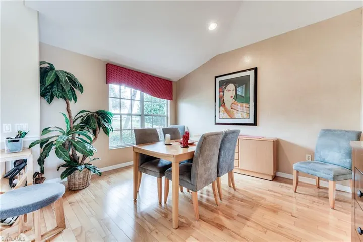 Dining space featuring lofted ceiling, recessed lighting, light wood-style flooring, and baseboards