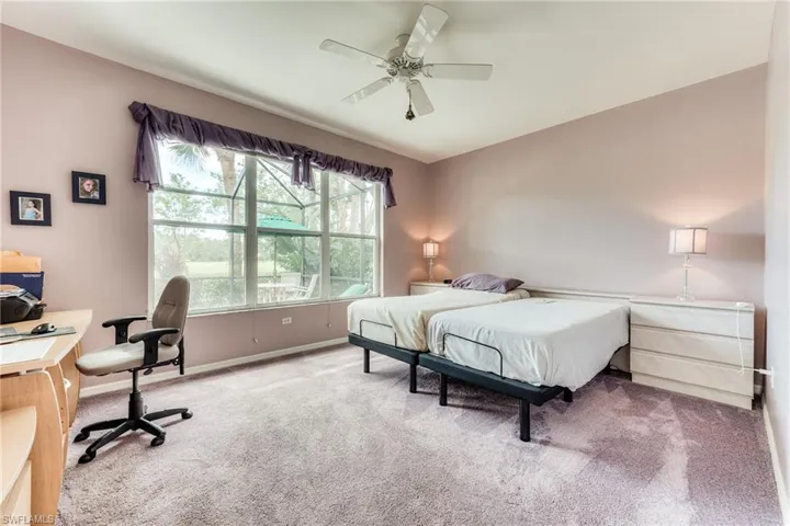 Bedroom with ceiling fan, baseboards, and carpet flooring