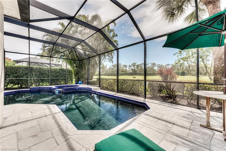 View of pool with a lanai, a patio area, and a pool with connected hot tub