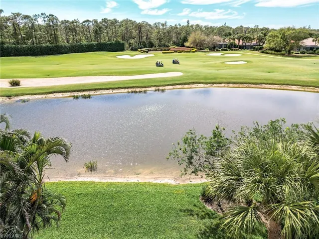 View of property's community with a water view, golf course view, and a lawn