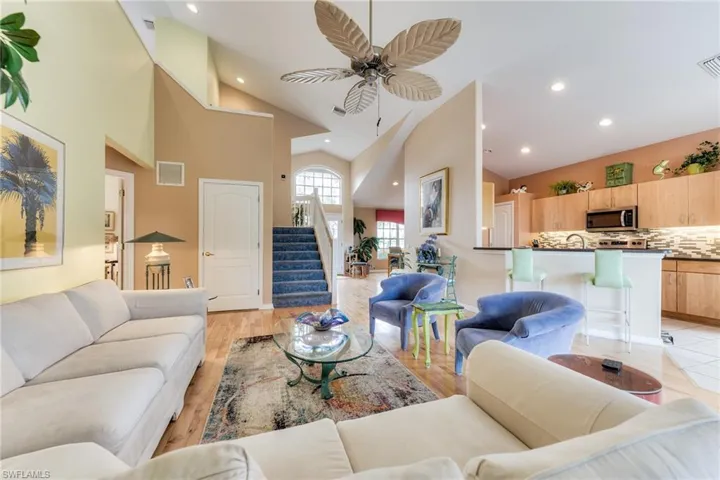 Living area featuring recessed lighting, visible vents, stairway, light wood-style floors, and ceiling fan