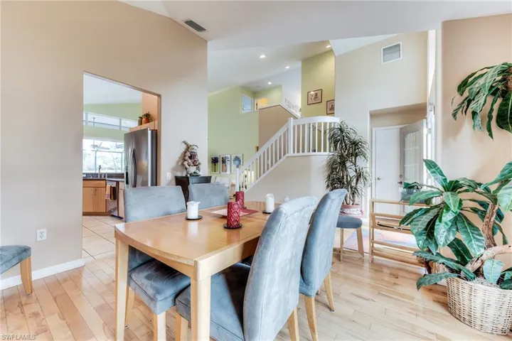Dining space featuring light wood-style floors, stairs, visible vents, and recessed lighting