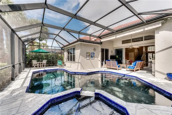 View of swimming pool with a patio area, a pool with connected hot tub, outdoor lounge area, and ceiling fan