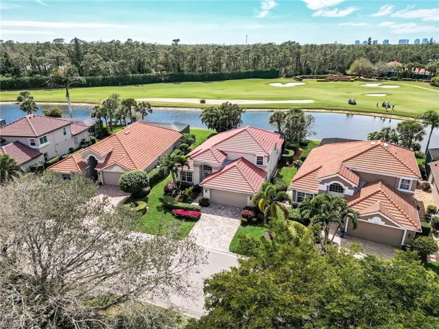Aerial view featuring golf course view and a water view