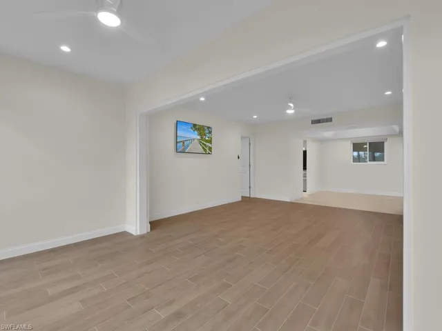 Living room with ceiling fan and tile floor