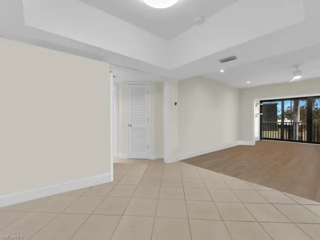 Dining and Living rooms with ceiling fan and tile floorwood-type flooring