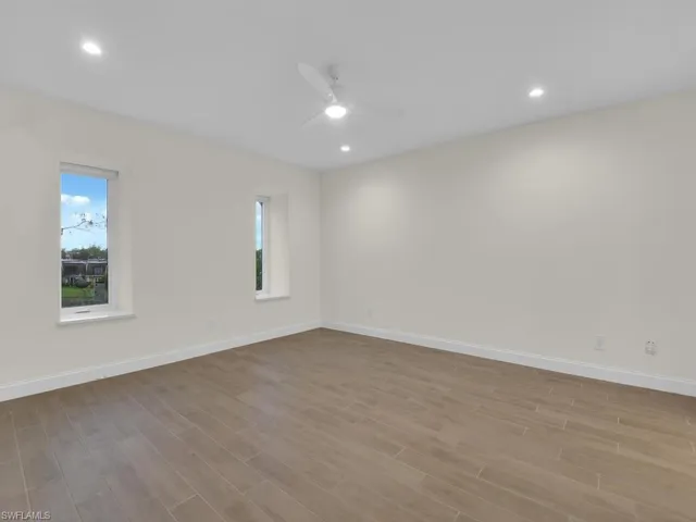 Primary room with ceiling fan and light hardwood / wood-style flooring