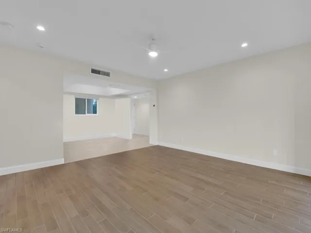 Living room  and dining room with ceiling fan and tile floor