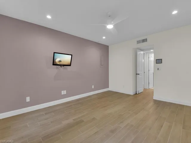 Spare room featuring ceiling fan and light wood-type flooring