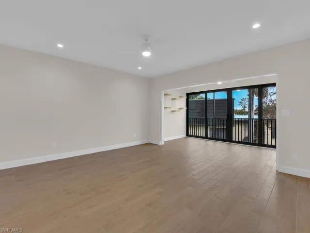 Living room with ceiling fan and tile floor
