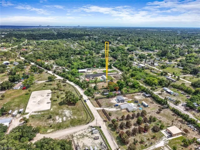 Aerial perspective showcasing expansive treed surroundings with distant city skyline