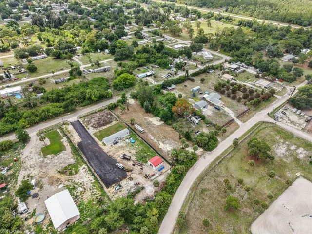 Expansive rural-style community with numerous parcels, established trees, and unpaved roads