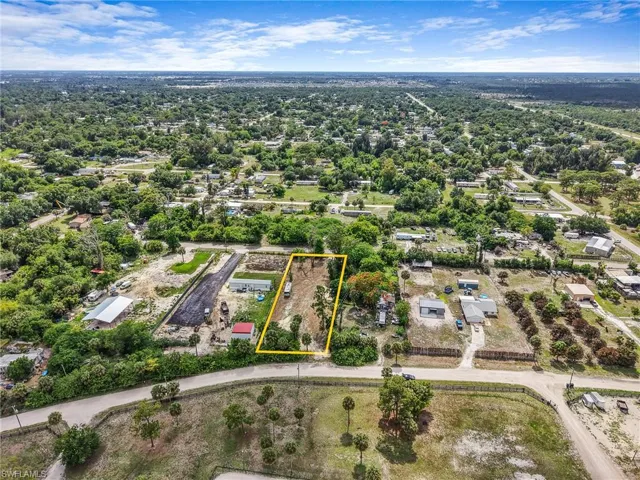 Expansive lot outlined in yellow, featuring mature trees and a substantial land area