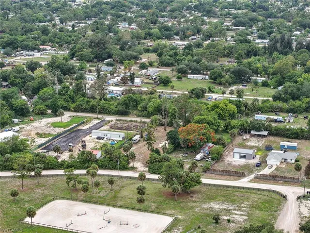 Expansive rural-style setting featuring a fenced equestrian riding arena