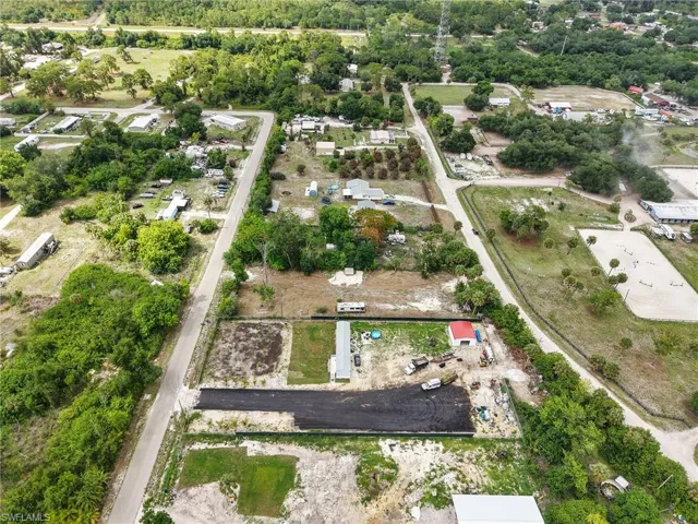 Aerial perspective showcasing multiple parcels of land with varied stages of development