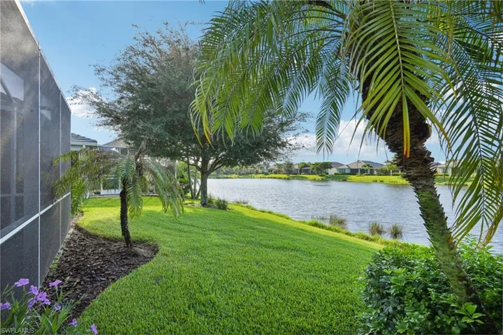 View of yard featuring a lanai and a water view