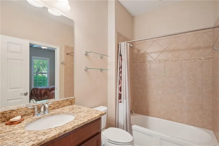 Full bathroom featuring vanity, toilet, and shower / tub combo